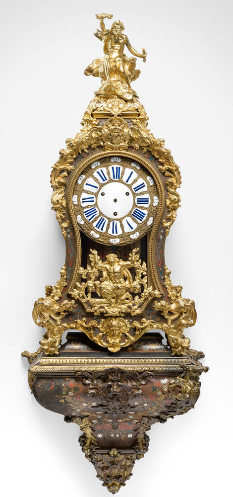 Two pendulum clocks with Hercules mount on front on corresponding brackets